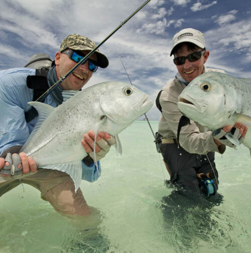 Two guys showing off their GT's caught with Alphonse Fishing Co™