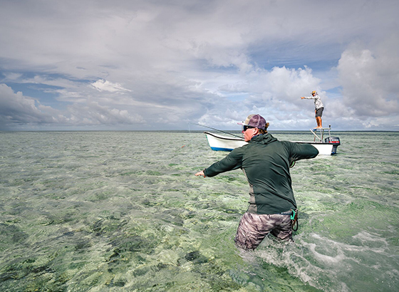 Fly fisher getting ready to fight the giant trevally on a fly with Alphonse Fishing Co™