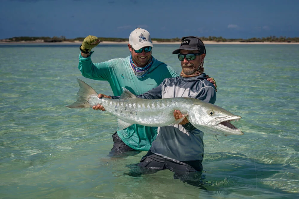 Angler with barracuda caught on a fly