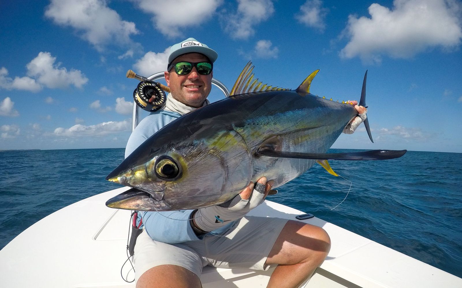 Angler with a yellowfin tuna caught on a fly 